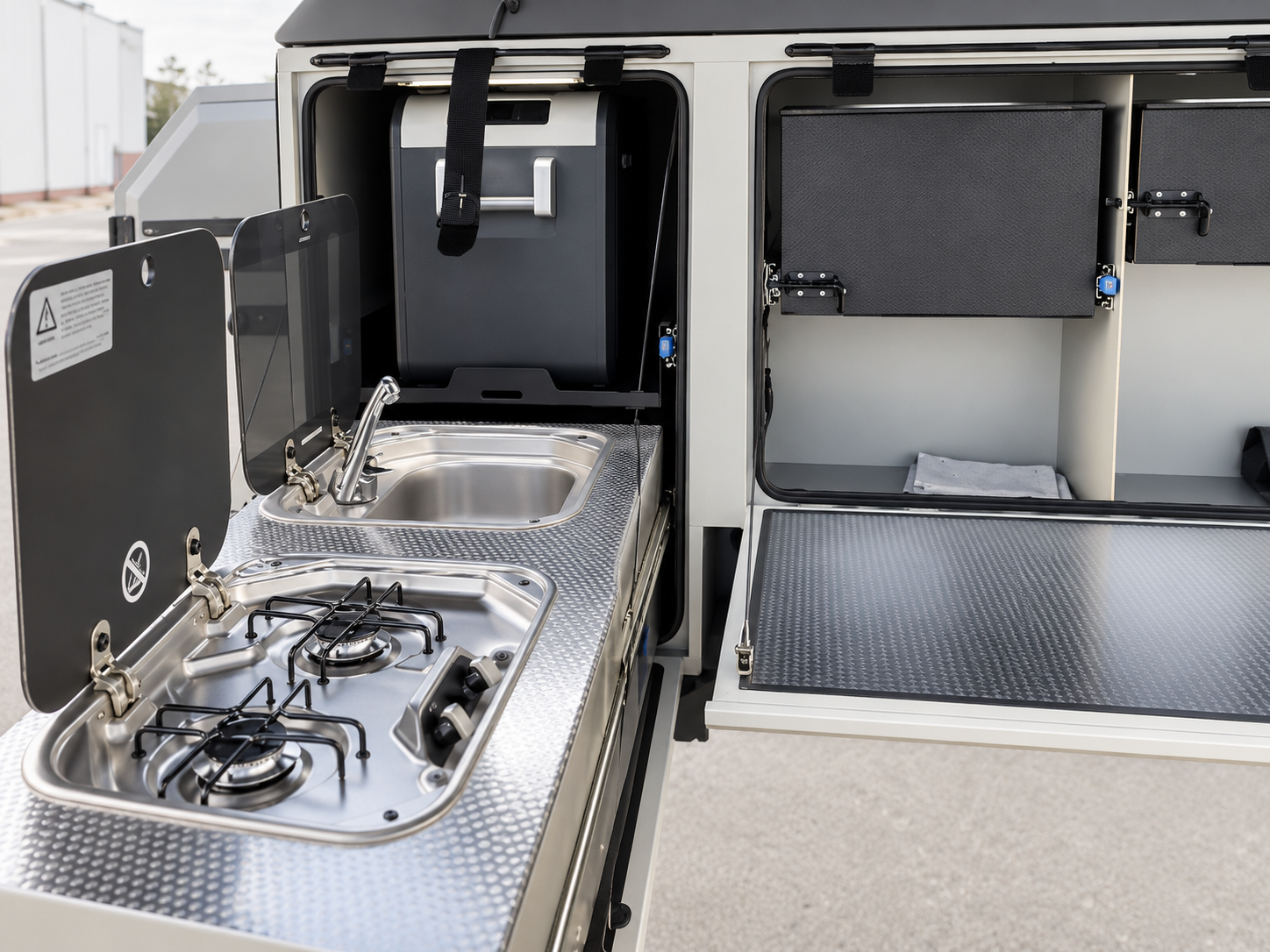 Base Camp 3B slide-out kitchen with stove, sink and open storage compartments