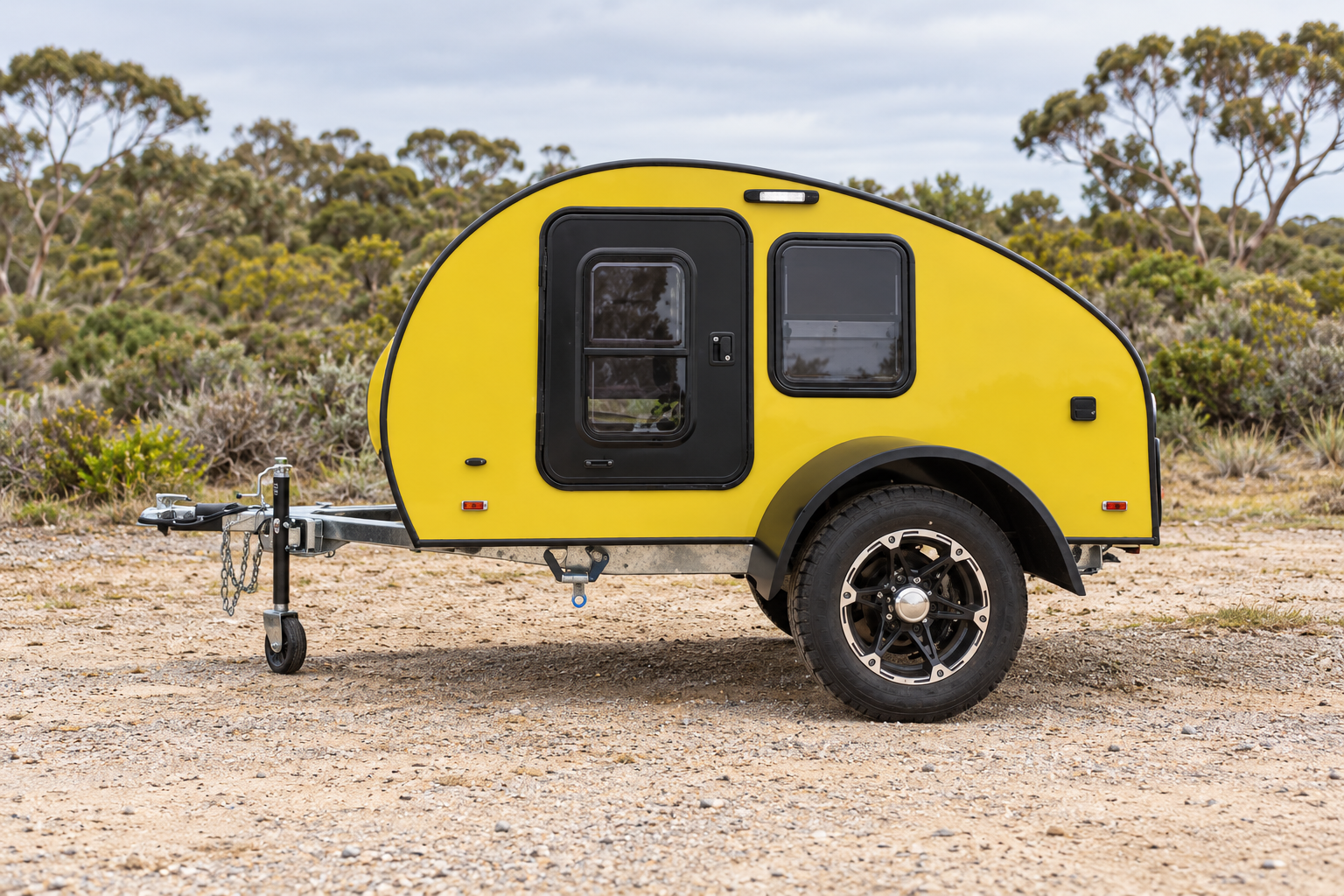 Yellow Comma CC teardrop camper in an Australian coastal scrub setting